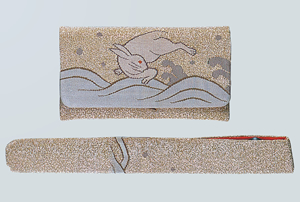 Woman's gold tsuzure-nishiki pocket tobacco pouch with wave and rabbit pattern