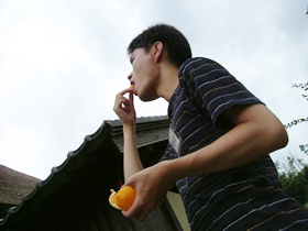 曇り空の下、好物のミカンをほおばる。